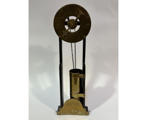 A 1920s reproduction R Mannin of Bath oak framed brass and copper water clock, the engraved dial and single hand with chain a