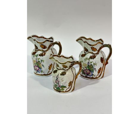 Two Victorian ironstone Wesley Powell&nbsp; copper luster moulded jugs decorated with enamel decorated leaves and floral spra