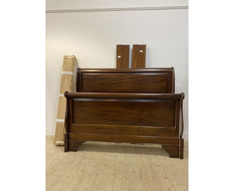 A French style stained hardwood sleigh bed frame with scrolled and panelled head and foot board, moulded side rails, complete