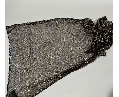 A 1920's Egyptian Assuit shawl, in brown, characteristically decorated with hammered yellow metal beads in geometric patterns