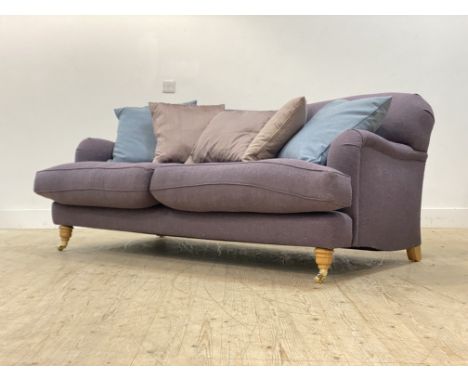 Charlotte James for Anta, a traditional 'Howard style' two seat sofa, the frame and deep squab cushions upholstered in lilac 