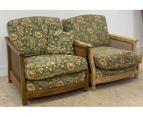Ercol, a vintage pair of elm and ash bergere lounge chairs, each with seat and back upholstered in floral fabric, raised on t