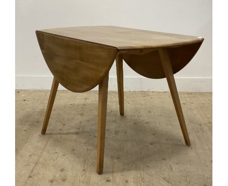 Ercol, an elm and beech drop leaf dining table, the oval top raised on square tapered supports. H72cm, 113cm x 124cm.