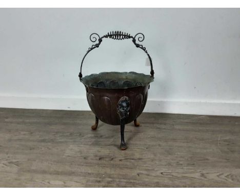 COPPER PLANTER, 19TH CENTURY  with scroll top handle, the bowl on raised pad feet52cm high