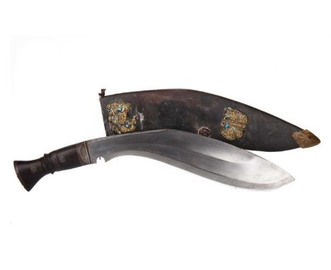 NEPALESE KUKRI KNIFE EARLY 20TH CENTURY with steel mounted hardwood hilt, unsigned, the leather scabbard with brass mounts42c