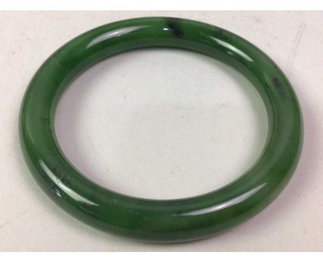 JADE BANGLE, ALONG WITH A NECKLACE AND PAIR OF EARRINGS the bangle of rounded tubular form, the necklace formed with a row of