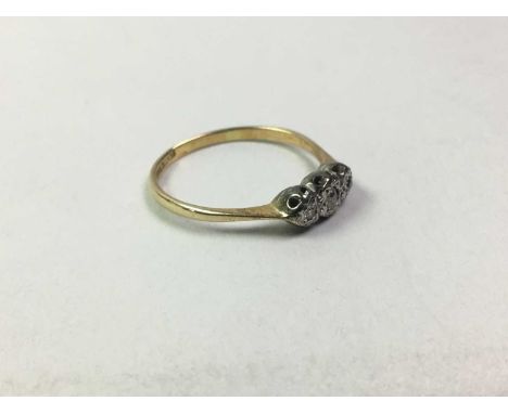 TWO DIAMOND RINGS, each set with three small diamonds, one marked for eighteen carat gold, the other unmarked, size H 1/2 and