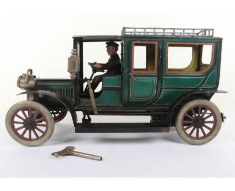 Carette a large tinplate clockwork Limousine, circa 1910, finished in green with cream lining and red window frames, hinged d