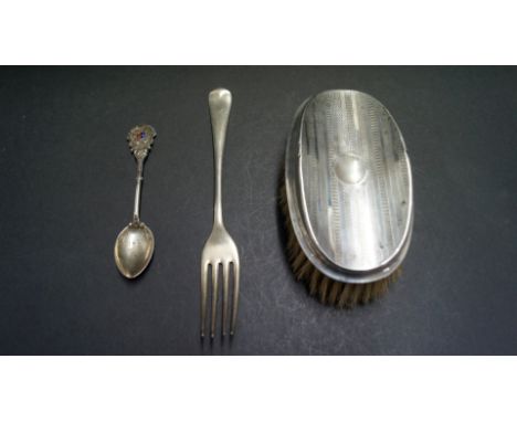 A silver hair brush; together with a silver fork and a Deva Lodge silver and enamel spoon.