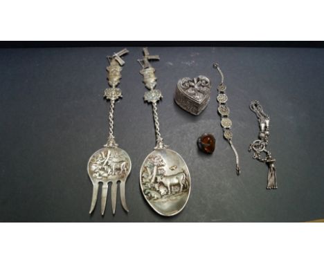A Dutch white metal serving spoon and matching fork; together with a filigree metal heart shaped box; a metal bracelet;a meta
