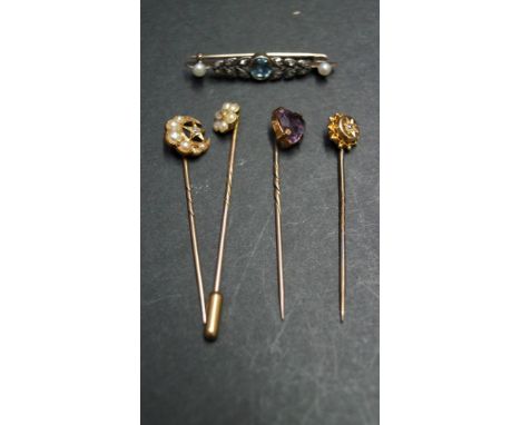 An 18ct gold diamond and pearl set stick pin; together with a 9ct stick pin set heart shaped amethyst with steel pin; two unm