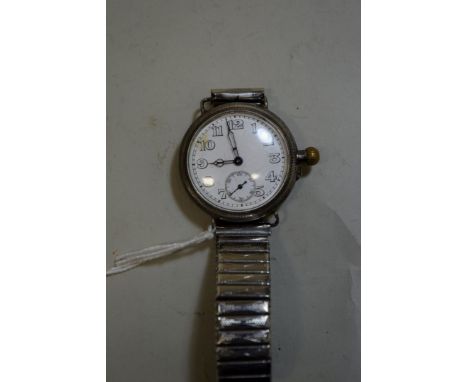 A circa 1915 trench watch in silver coloured case, having 3cm white enamel dial decorated Arabic numerals with subsidiary sec