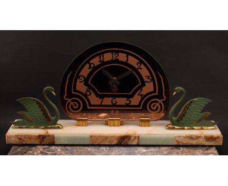 An Art Deco period mantle clock, demi-lune brass face with Arabic scallop shaped chapter, flanked by a pair of painted and gi