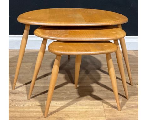 An Ercol beech and elm Pebble nest of three occasional tables, unbadged 