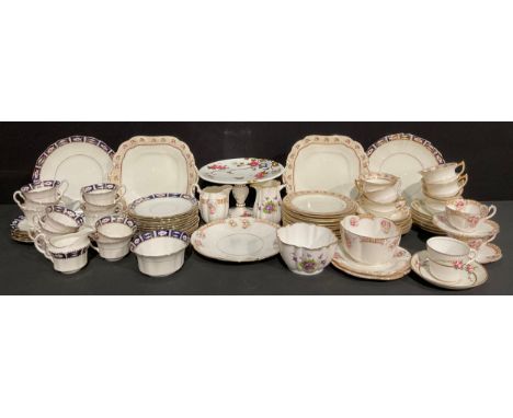 An Aynsley part tea service, decorated with a band of pink roses on a gilt ground, comprising cake plates, side plates, cups 