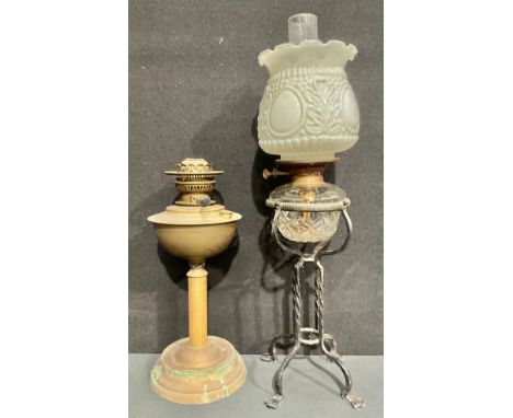 A brass oil lamp, opaque moulded white glass shade; a wrought iron oil lamp, cut glass reservoir, Duplex twin burner, chimney