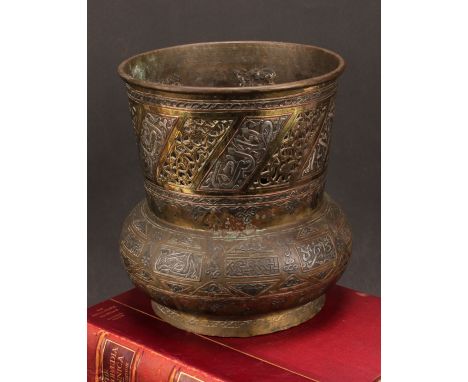 A Middle-Eastern silvered and copper damascened brass mosque lamp, pierced and decorated with Arabic verse and Islamic motifs