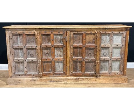 An Indian mango Kothla majus design sideboard, rectangular top above two pairs of doors, each enclosing a shelf, 93cm high, 1