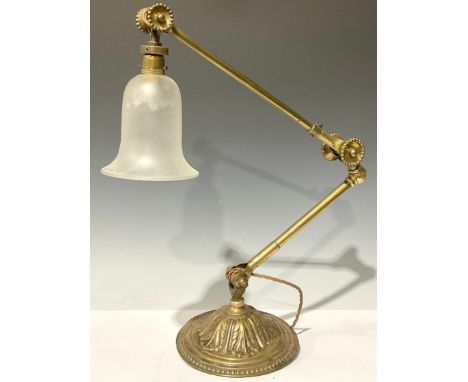 An early 20th century brass adjustable desk lamp, domed circular base embossed with acanthus, frosted glass shade 