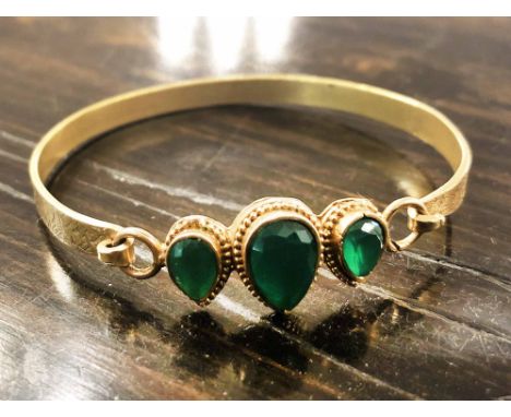 BANGLE, unmarked, yellow metal with three pear shaped green stones.