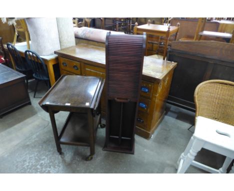 An oak trolley and a hardwood tambour front CD cabinet 