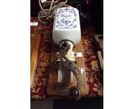 A vintage French coffee grinder mounted on wooden base