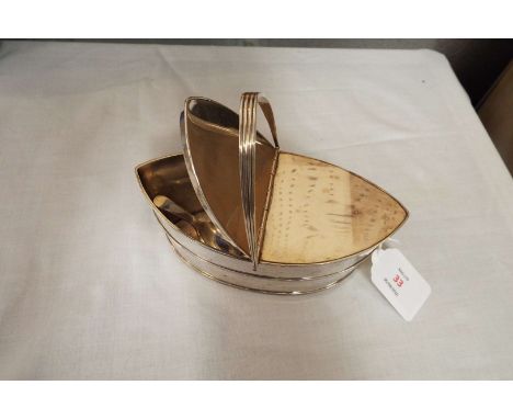 Two Sheffield silver caddy spoons and a silver plate boat shaped caddy