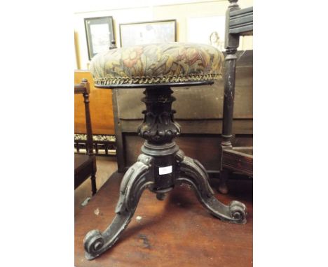 A Victorian carved acanthus leaf adjustable footstool with tapestry seat