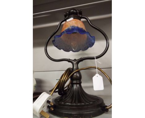 An Art Nouveau style desk lamp with blue and pink glass shade