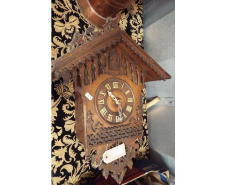 A good quality 19thC carved oak cuckoo clock with two train weight driven movement 