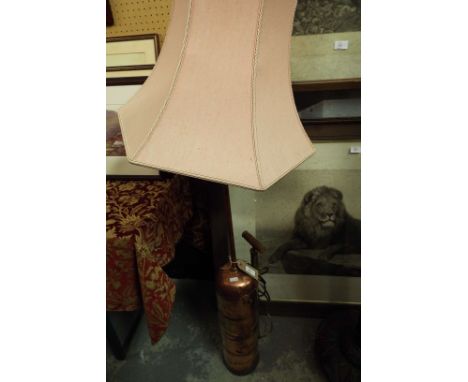 A copper and brass pump converted to a lamp with lampshade