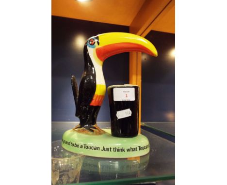 A Carlton-ware Guinness lamp base 'How Grand to be a Toucan Just Think What a Toucan Can Do'   Missing lamp electrics and sha