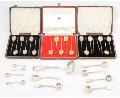 Silver condiment spoons, three cased sets of spoons (one enamel spoon missing), sauce ladle.