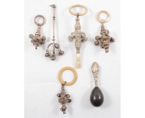 Silver rattle, with mother of pearl handle and later(?) teething ring, three similar rattles, an all metal rattle engraved "B