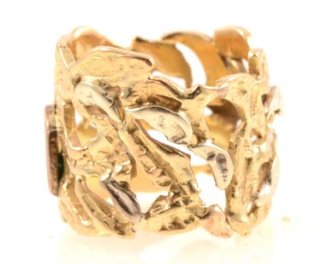 A yellow and white metal modern pierced leaf design ring,15mm wide, testing as gold, ring size K centre, 10gm.
