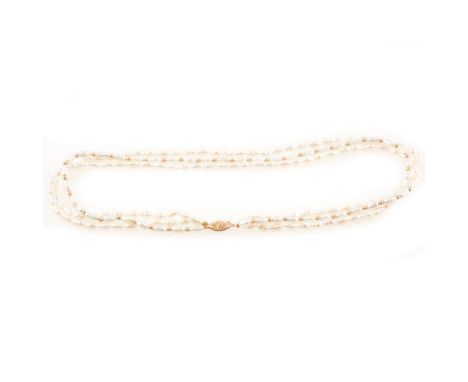 A freshwater pearl three string choker, the pearls on one string spaced by small round golden beads, 42cm, filigree clasp mar
