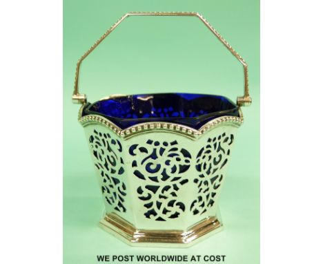 A Victorian blue glass linered hallmarked silver swing handled octagonal basket, height including handle 15cm, Sheffield 1848