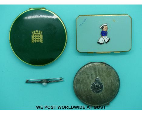 A hallmarked silver compact, two Stratton compacts and an arts and crafts brooch set with a pearl 