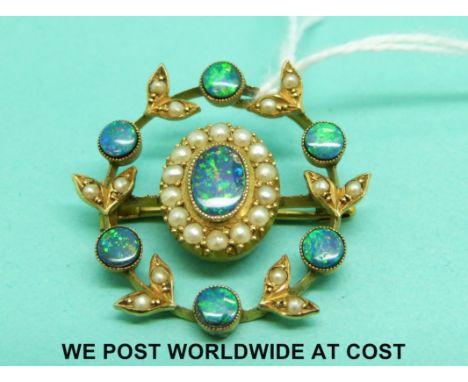 A yellow metal brooch set with boulder opal doublets and seed pearls