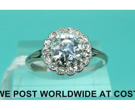 A Victorian platinum ring set with an old English cut diamond of approximately 1.68ct surrounded by smaller diamonds (size S)