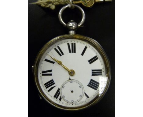 A hallmarked silver open faced key winding pocket watch with inset subsidiary seconds dial and black Roman numerals to the wh