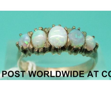 A yellow metal ring set with five opal cabochons (size N)