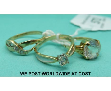 A yellow metal ring set with paste and two 9ct gold rings set with cubic zirconia 