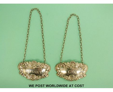 A pair of hallmarked silver whisky and gin bottle tickets