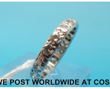 A white metal ring set with 17 diamonds each measuring approximately 0.1ct (size P)