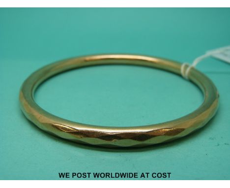 A 9ct gold flapper bangle with faceted decoration (15.5g)