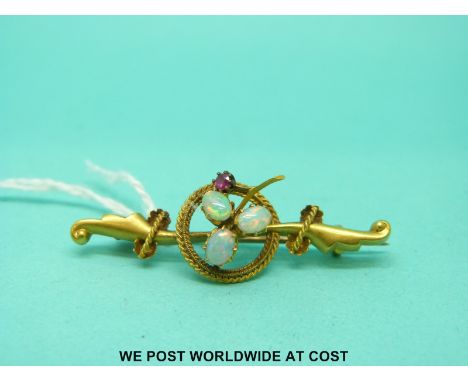 An Edwardian 15ct gold brooch set with three opals and a ruby 