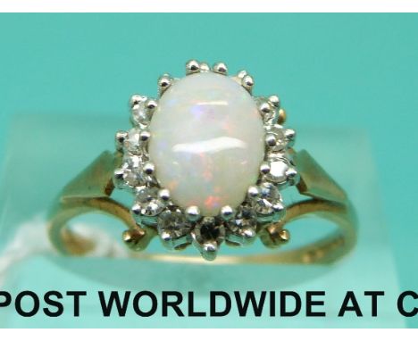 A 9ct gold ring set with an opal cabochon surrounded by diamonds, with insurance valuation from SafeGuard for £600 (size N)