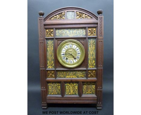 An aesthetic / Arts & Crafts clock with ceramic panels surrounding an enamel and gilt dial, the two-train anonymous movement 