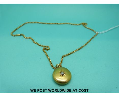A Victorian locket marked 15ct set with a pearl on a yellow metal chain marked 15ct (9.8g)